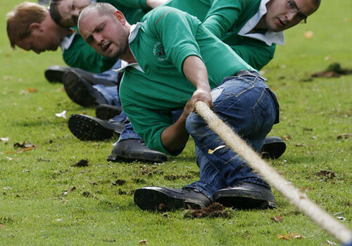 Spiel- und Sportseil für Tauziehen, Klettern und andere Aktivitäten Männer beim Tauziehen mit einem robusten Kletterseil auf einer Wiese